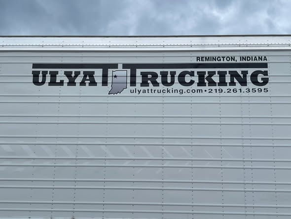 Ulyat Trucking logo lettering on the side of a trailer in Remington, Indiana